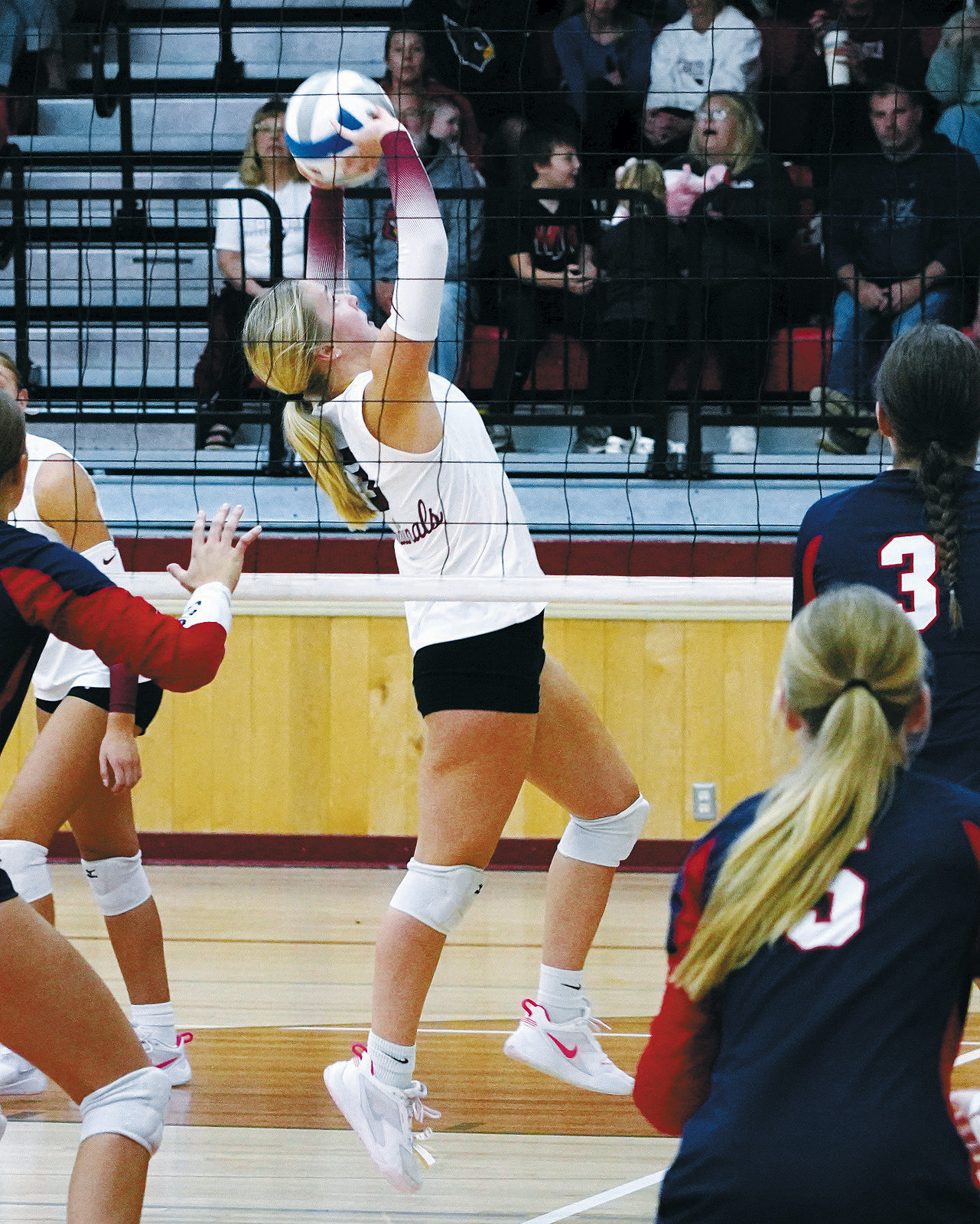 Payton Hall with a backset to her teammate at the Langdon Invitational Tournament on Oct. 12. Photo by Larry Stokke.