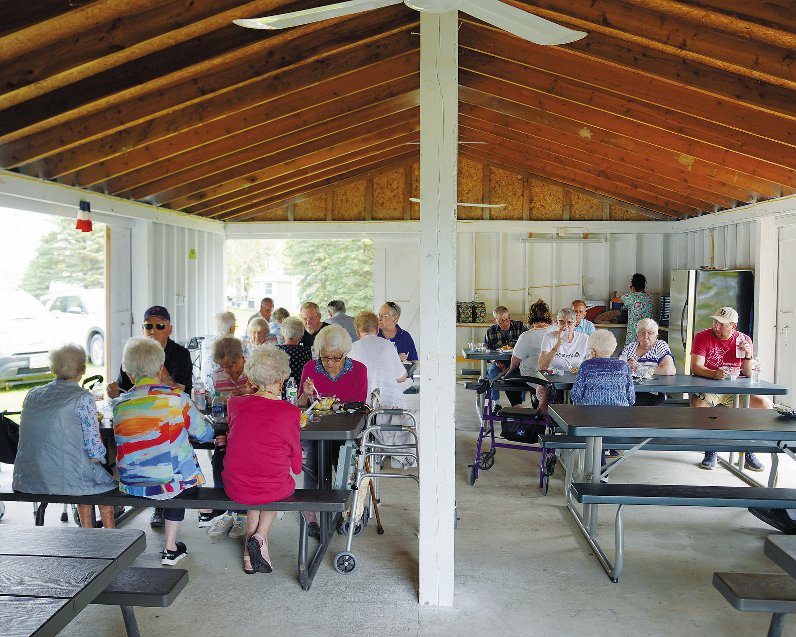 Attendees enjoying some refreshments and snacks in the shade. Photo by Larry Stokke.
