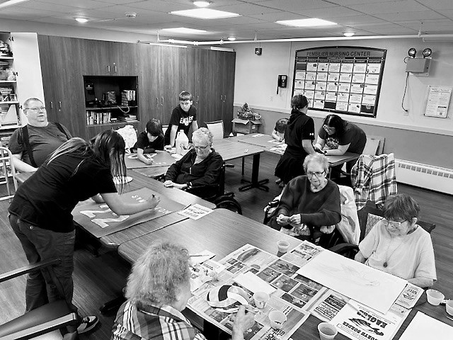 The North Border Walhalla sixth graders making posters with PNC residents.