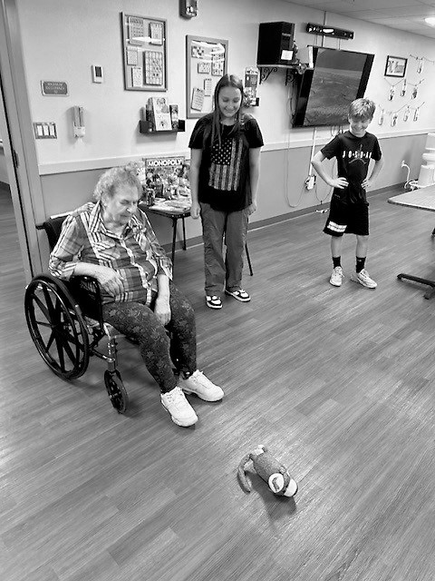 CeCe, Nolah, and Brantley watching the sock monkey dance.