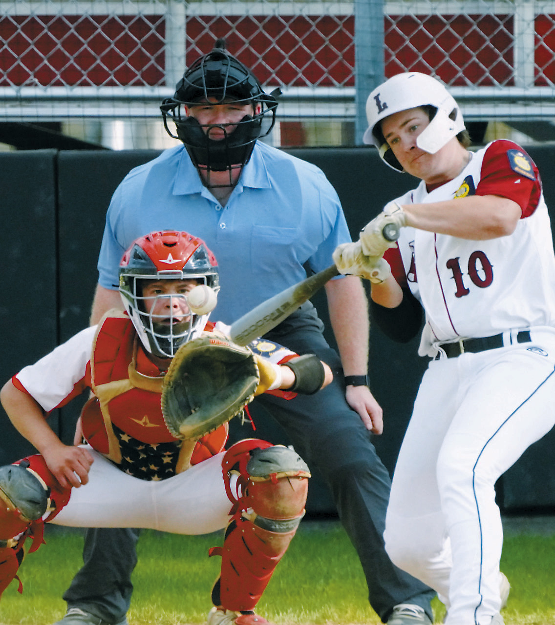 Devin Hakanson drives the ball into the outfield while facing off with MayPort. Former Red Sox player, Grant Romfo, was the plate umpire for the game. Photo by Larry Stokke.