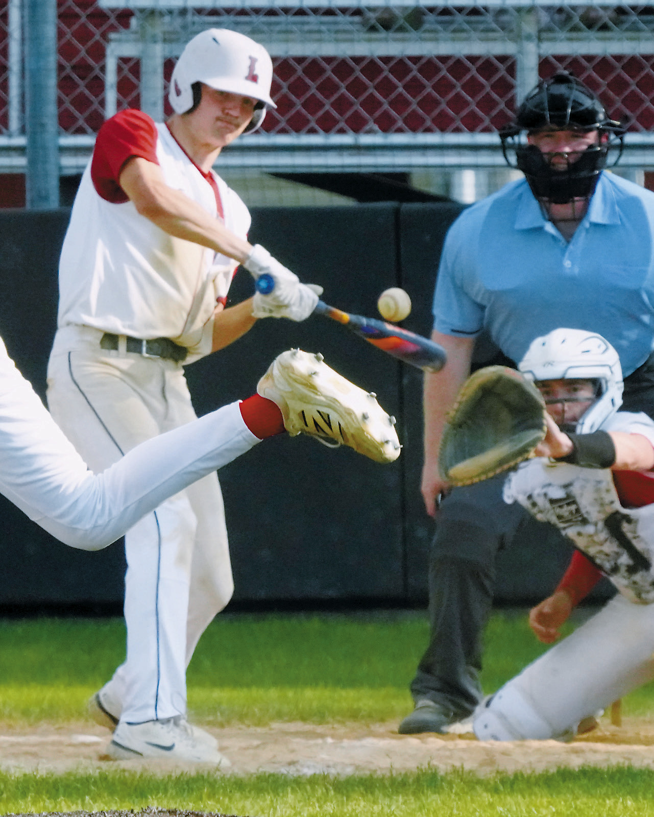 Cody Amble connects for a base hit against MayPort. Photo by Larry Stokke.