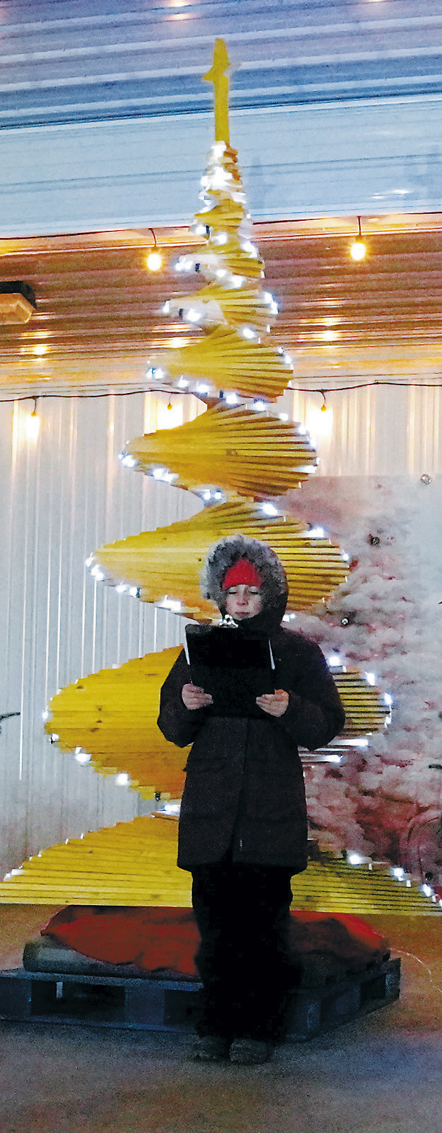 Kamdyn Krom lit the Christmas Tree on Boyds Block and announced the names of the three winning floats in the Parade of Lights. Photo by Larry Stokke.