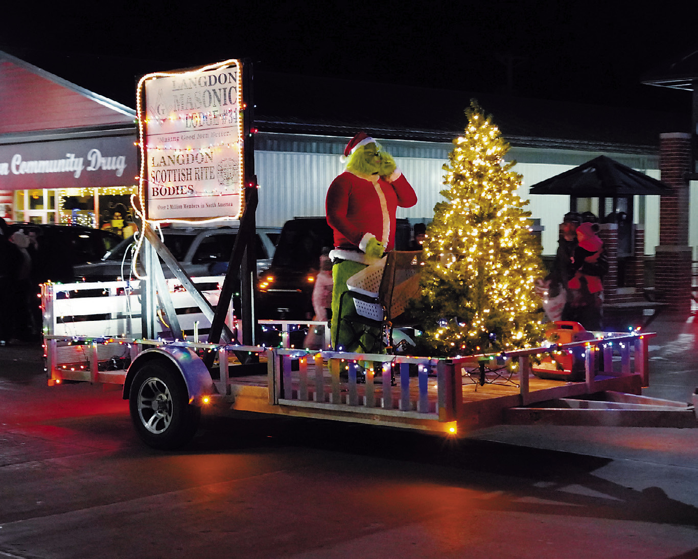 The Langdon Masonic Lodge along with the grinch and a Christmas tree ride along in the Parade of Lights through Langdon. Photo by Larry Stokke.