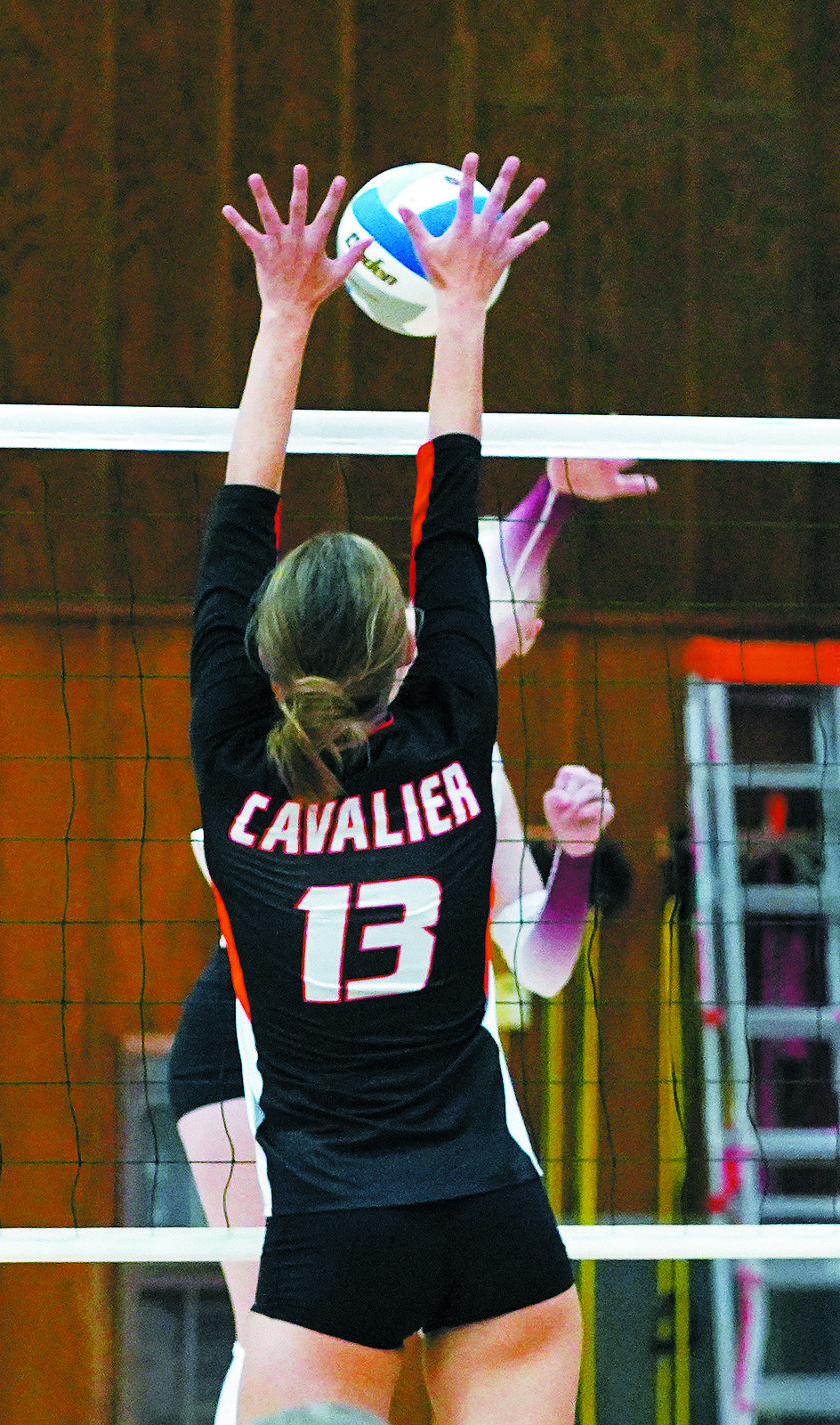 Ariana Thebeau with a stuff block against the Cardinals. Photo by Larry Stokke.
