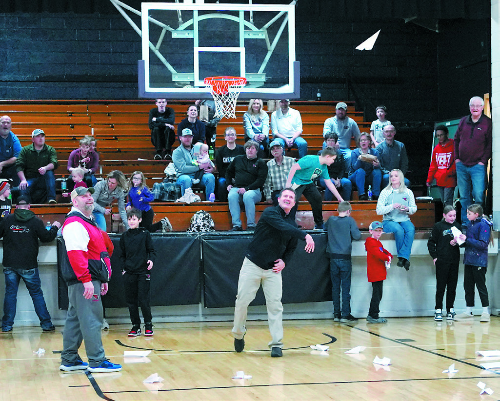 Marty Amble won the halftime fundraiser by making and sending his paper airplane the furthest in Munich at the girls basketball game. Photo by Larry Stokke.