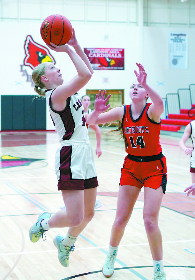 Hilary Haaven eyes the rim and adds two points to the Cards' score in the win over the Patriots. Photo by Larry Stokke.