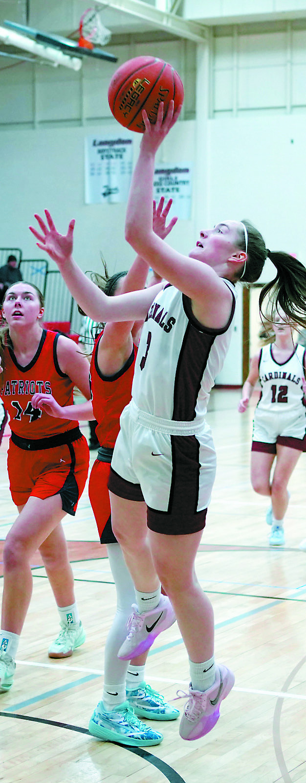 Meredith Romfo with a layup in the Cards' win over MPCG in Langdon on Jan. 18. Photo by Larry Stokke.