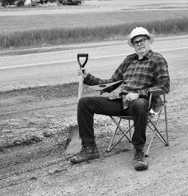 Hold my beer! An alleged highway engineer taking a much needed break from the exhaustive work of watching the frost boil grow on Highway 1 by the hardware store.