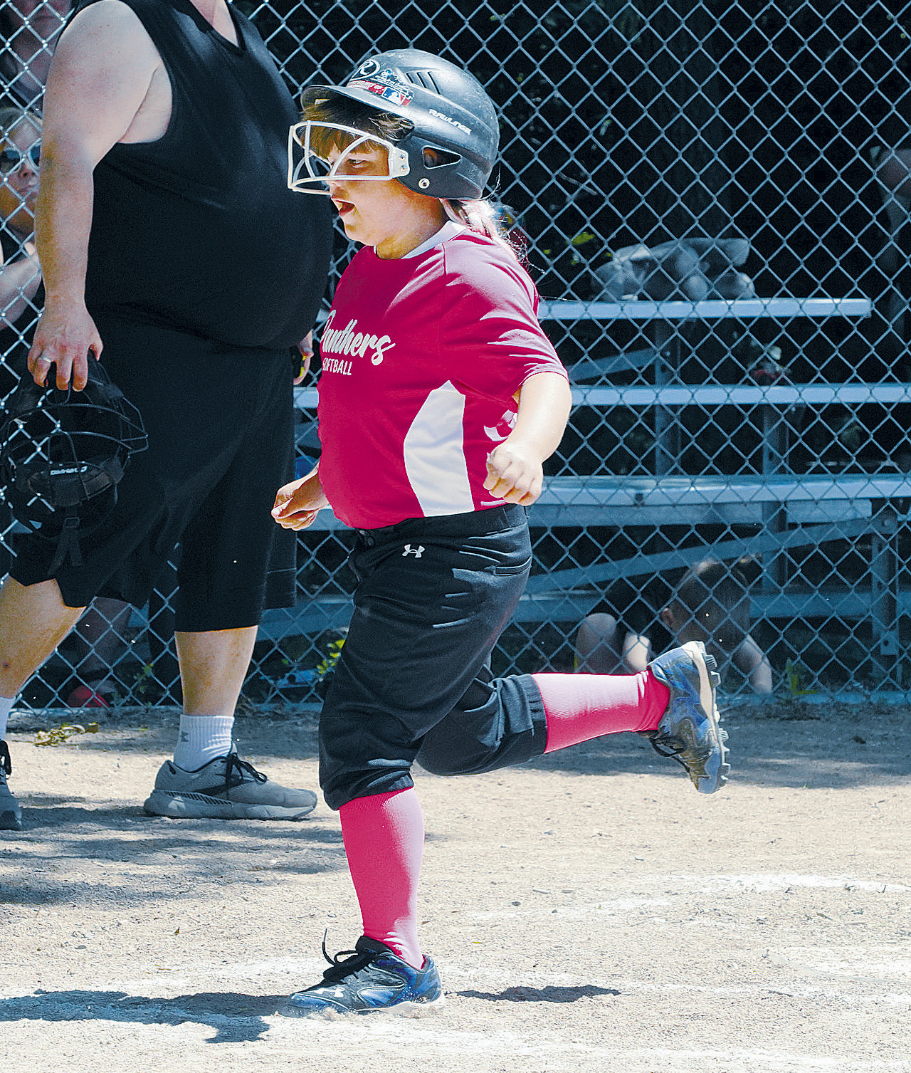 Andrea Finnson crosses home plate and scores a run for the Pink Panthers. Photo by Larry Stokke.