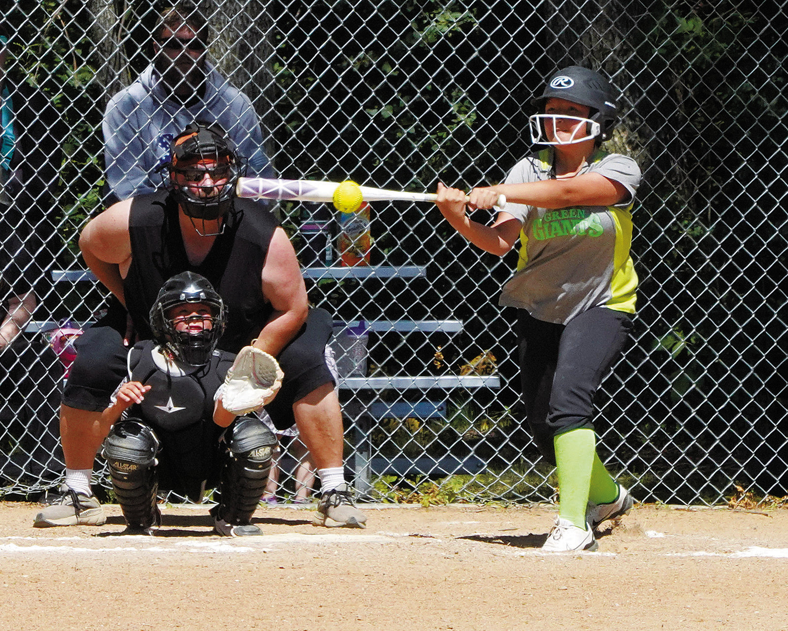 Myla Domres connects for a base hit against the Pink Panthers. Photo by Larry Stokke.