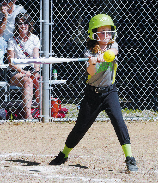 Aria Olson sends the ball into the outfield for a base hit. Photo by Larry Stokke.