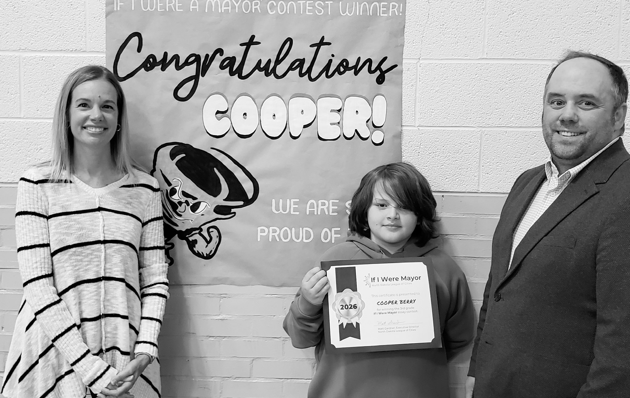 Cooper Berry, a third-grade student at Cavalier School, holds his award after winning the North Dakota League of Cities’ statewide “If I Were Mayor” essay contest.