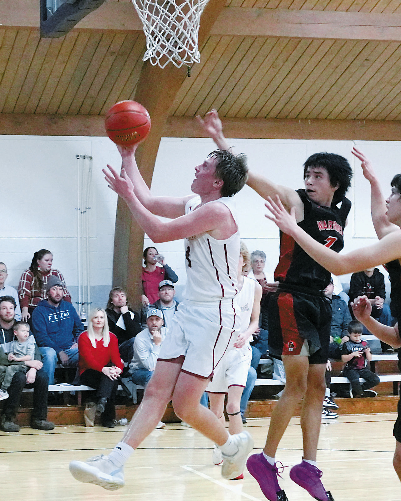 Player of the Game Levi Swanson had three 3 point baskets and finished with 16 points in the win over Warwick. Photo by Larry Stokke.