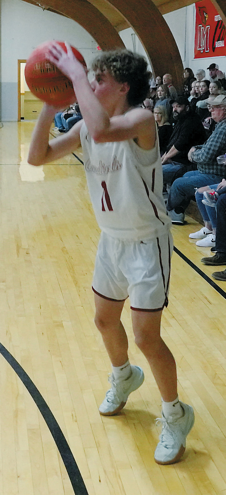Conner Mitchell fires off a three point shot against the Warwick Warriors. Photo by Larry Stokke.