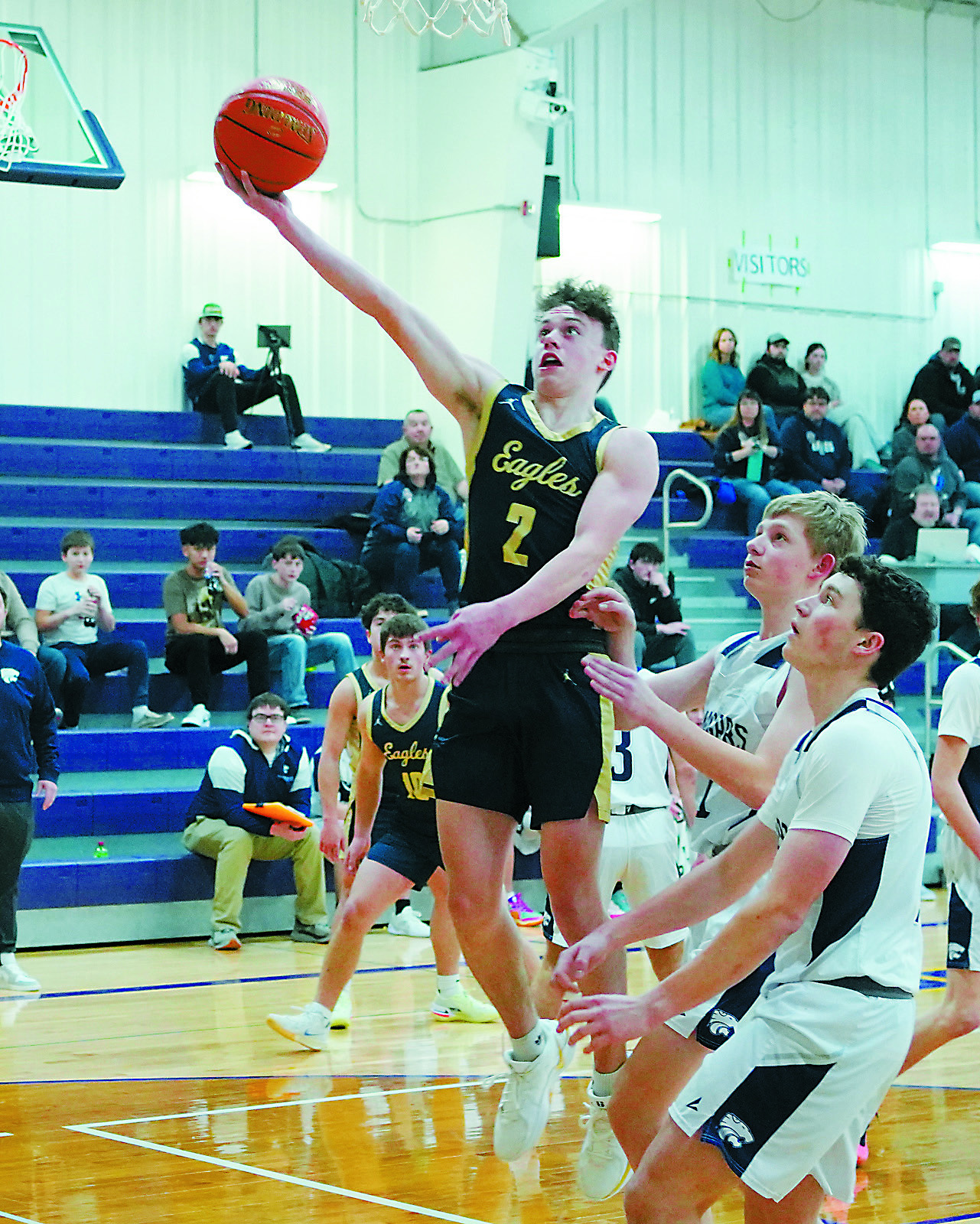 Player of the Game Kaden Moore eyes the basket and lays in a bucket during his game high 20-point night. Photo by Larry Stokke.
