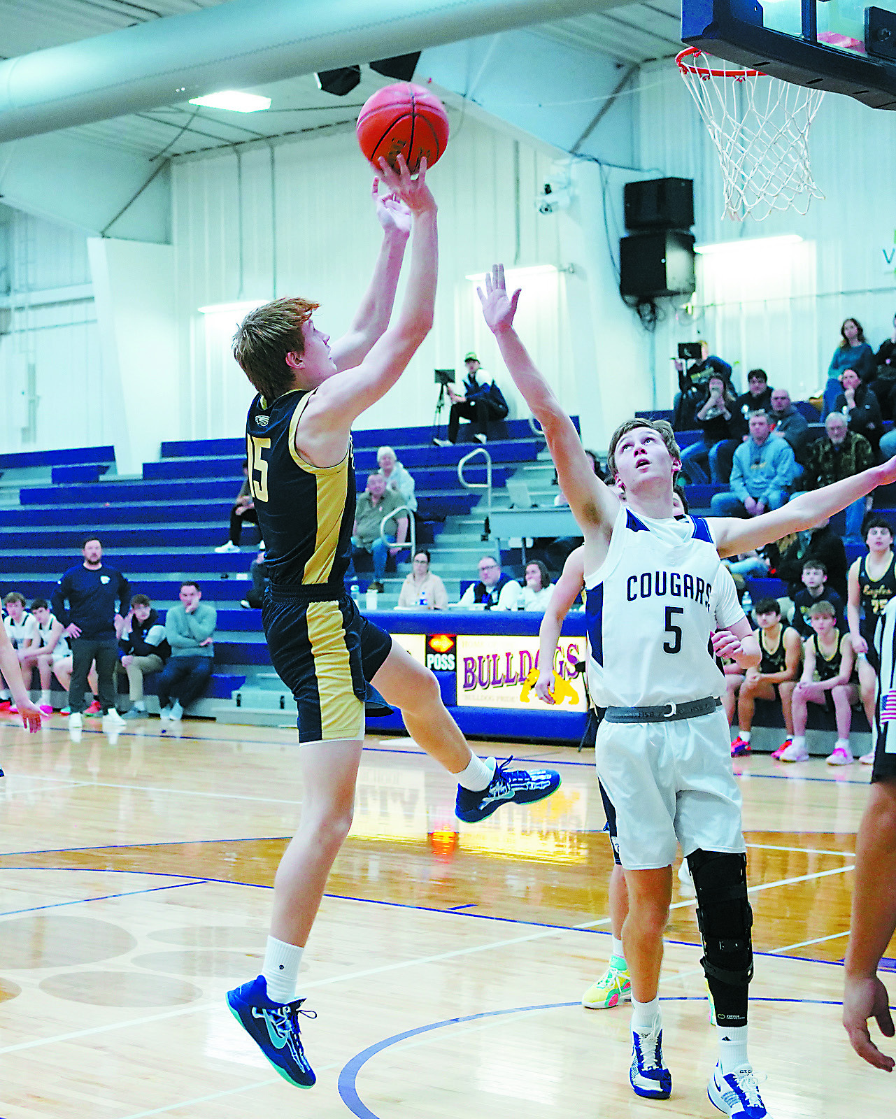 Garrett Willits puts up a shot over North Prairie's Player of the Game Jeffery Rosinski. Photo by Larry Stokke.