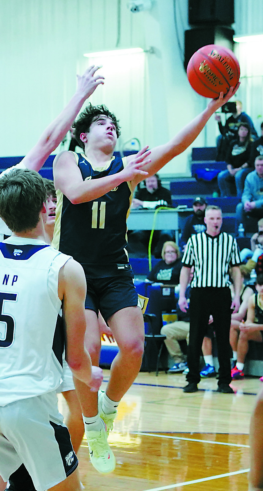 Grant Cosley lays in a left handed layup in their win over the North Prairie Cougars in Rolla. Photo by Larry Stokke.
