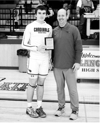 Eastyn Schafer received a plaque celebrating the 1000th point in his career. Photo by Larry Stokke