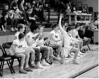 The Cards bench celebrates as the game gets closer to the final buzzer. Photo by Larry Stokke