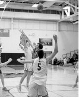 Senior Levi Swanson puts the Cards up by two points with 2.35 left on the clock. Photo by Larry Stokke
