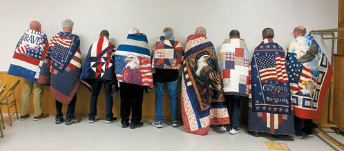 Recipients proudly display their Quilts of Valor following a recent presentation by American Legion Post 98. The handmade quilts are awarded to veterans touched by war as a symbol of comfort and appreciation for their service. Submitted photo