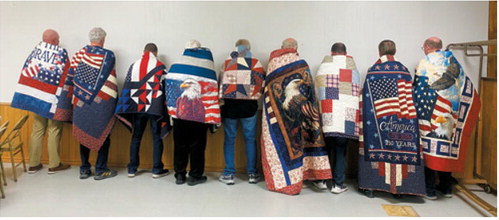Nine veterans were presented Quilts of Valor during a recent ceremony hosted by American Legion Post 98. Honorees included, from left, Chris Olson, Bob Swenson, Steven Lamping, Fr. William McDermott, Duane Olson, Tom Hardy, Tyler Hardy, Randy Vondal and Kenny Stremick. The local Quilts of Valor program has now honored 70 veterans. Submitted photo