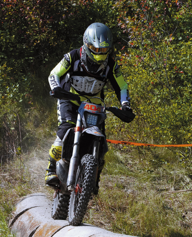 Ben Girodat crosses over one of the obstacles along the course at the Hare Scramble. Photo by Larry Stokke.