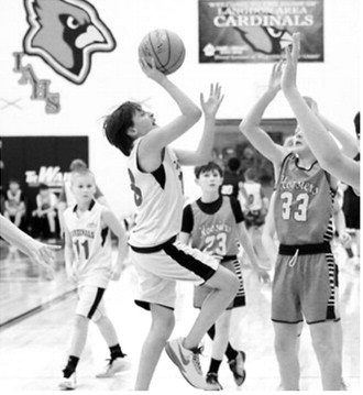 Zander Shipman puts up a shot over a Hoosier defender and lays it in the hole for two at the 5-on-5 tournament. Photo by Larry Stokke