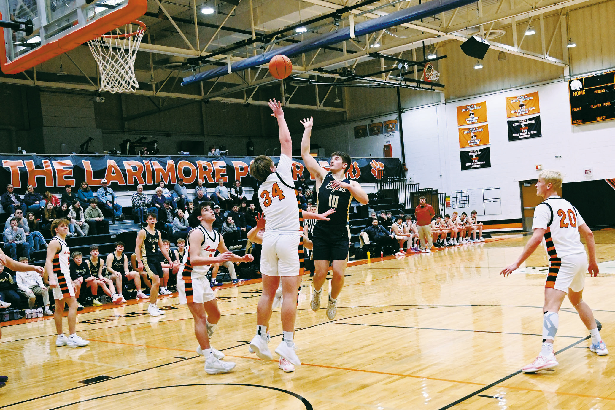 Colton Bailly takes the shot while being guarded by his opponent. Photo by Ashley Schafer.