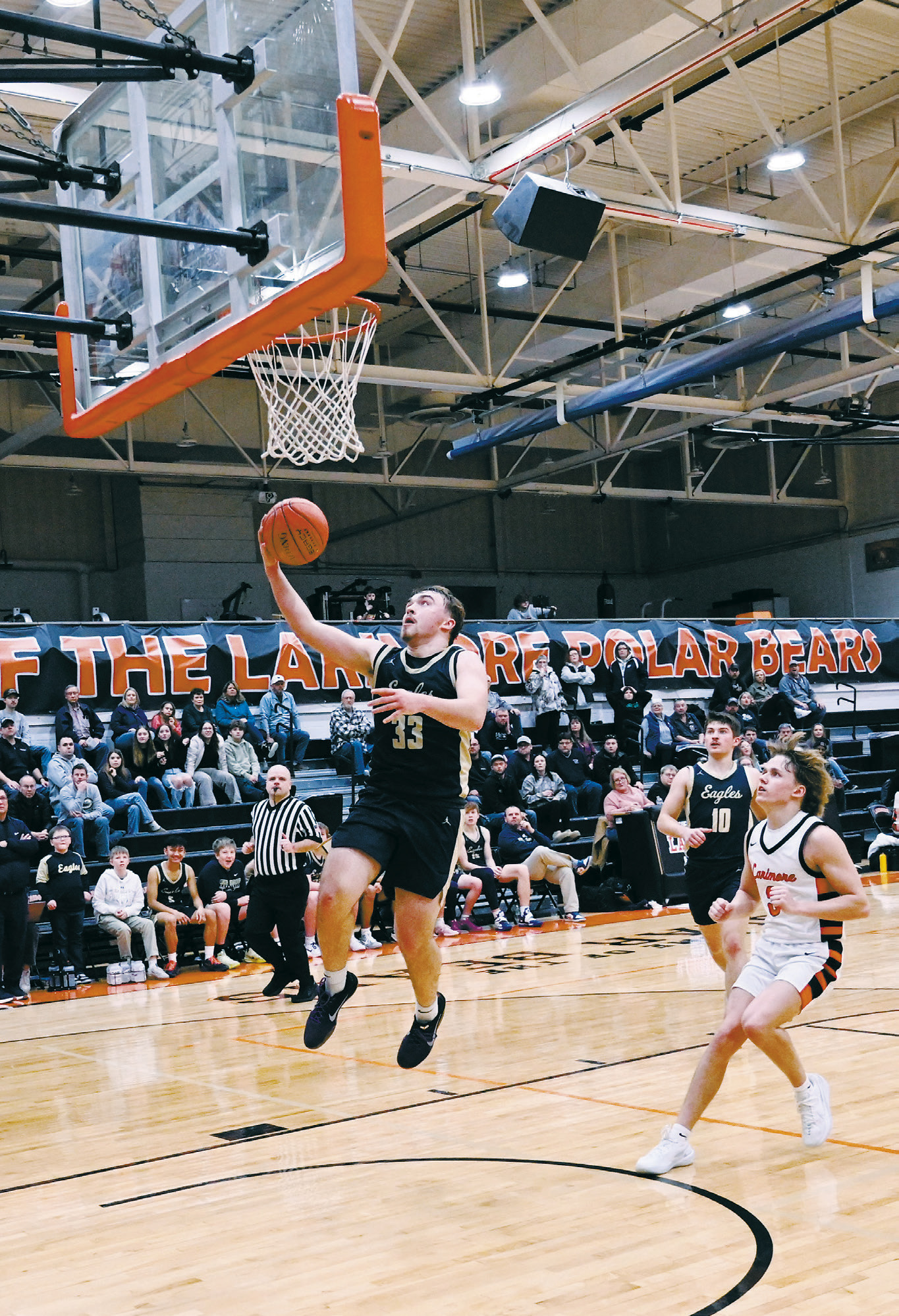 Kade Schafer drops the ball in for a layup in the Eagles’ win against Larimore. Photo by Ashley Schafer.