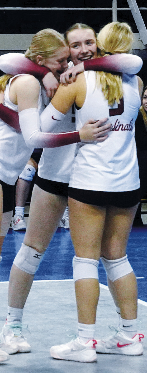 From (L-R) Hilary Haaven, Meredith Romfo, and Payton Hall embrace each other in excitement after the championship win. Photo by Larry Stokke.
