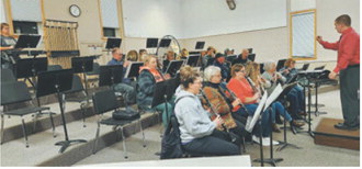 Members of the Langdon Community Band rehearse in the Langdon Area High School band room. Submitted photo