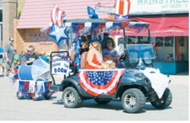 The Bjornstad family brought the boom to Walhalla's Fourth of July parade, decorating their float with patriotic colors and festive flair as they joined the community celebration along Main Street. Photo by Larry Stokke