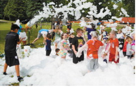 Kids dive into a mountain of foam during the popular foam party at Walhalla's Fourth of July celebration. Photo by Larry Stokke
