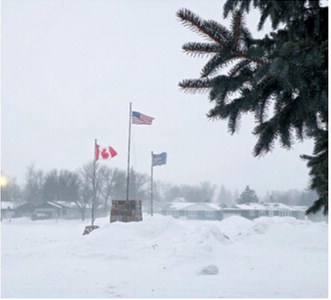 Winds whipped the flags in Langdon on Saturday , Jan. 31 as another Alberta Clipper moved through the area. Sarah Hinnenkamp / Borderland Press
