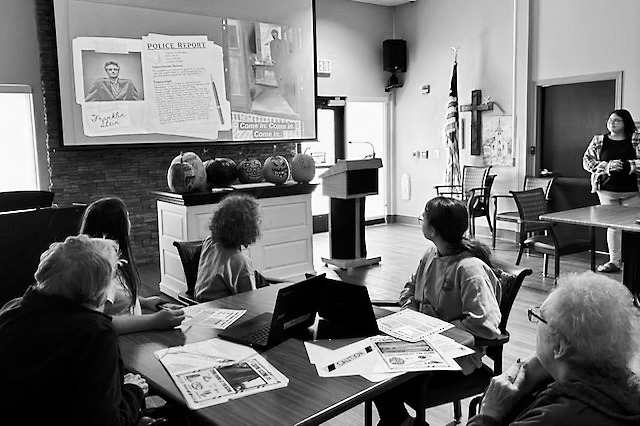 Students and residents alike study the clues for their mysteries.