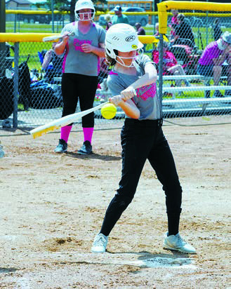 Billie Hanson connects for a base hit. Photo by Larry Stokke