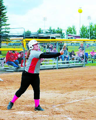 Sophia Vikan drives one into the outfield to score a run. Photo by Larry Stokke.