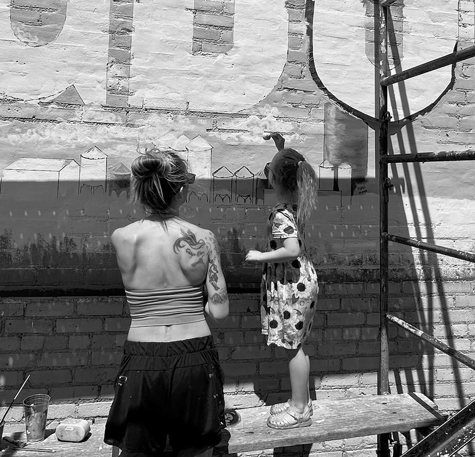 Quinn booping clouds into the mural.