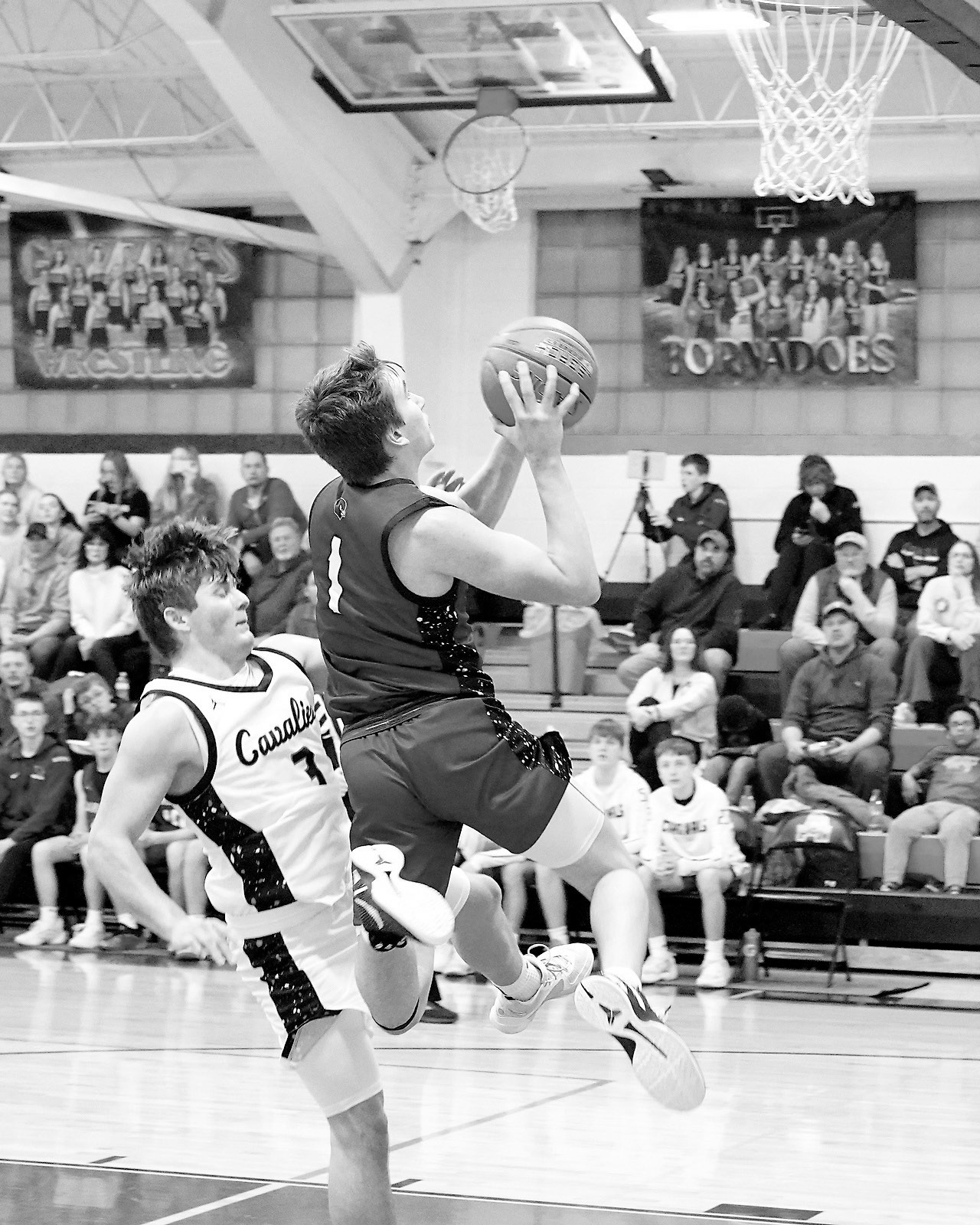 Eastyn Schaefer drops in one of his 14-points worth of baskets against Cavalier. Photo by Larry Stokke.