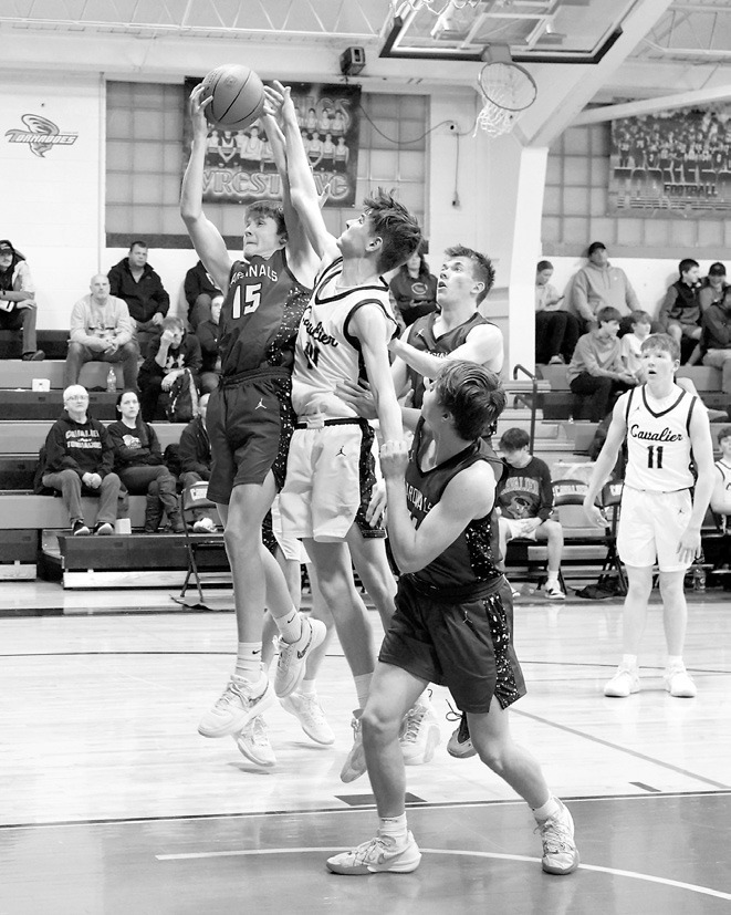 TJ Henderson pulls down a rebound in Cavalier on Jan. 23. Photo by Larry Stokke.