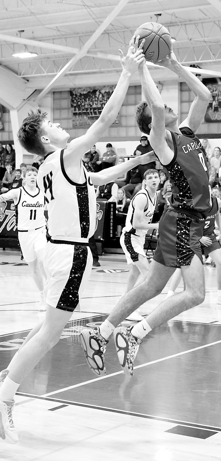 Jayden Lee drives down the lane and drops a basket in the win over Cavalier. Photo by Larry Stokke.