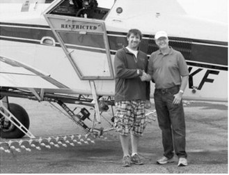 Kevin Forest, left, and his father, Kenny Forest, pose beside a Forest Flying aircraft. Kevin later assumed ownership of the family aerial application business, which Kenny founded in 1976. Photo courtesy of Forest Flying