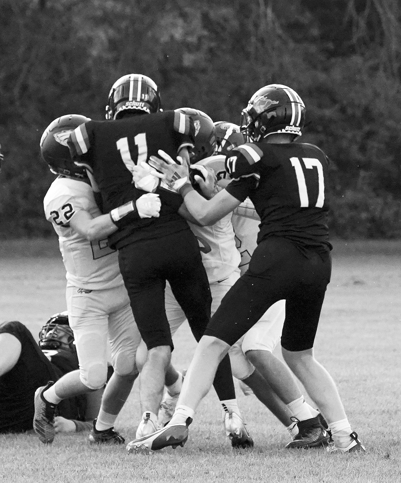 Zeke Symington and his teammates bring down Ben Gudajtes. Photo by Larry Stokke. Kade Schafer brings down Elijah Robinson for a turnover in downs. Photo by Larry Stokke.