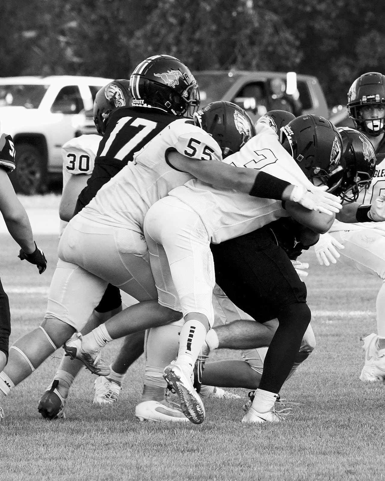 Oakley Brown and Gavin Symington tackle a Mustang in the Eagle's win over the Mustangs. Photo by Larry Stokke.
