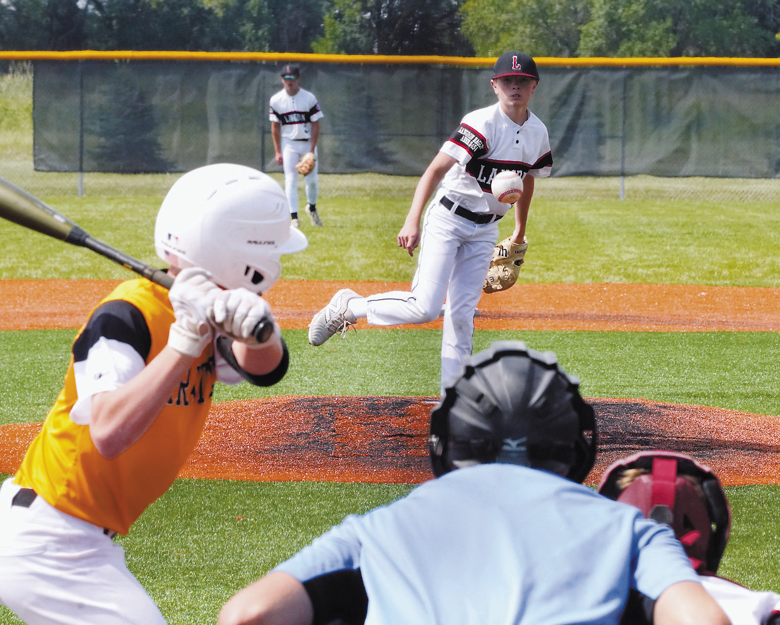 Gavin Gemmill watches as he sends a strike across the plate in the game against Park River. Photo by Larry Stokke.