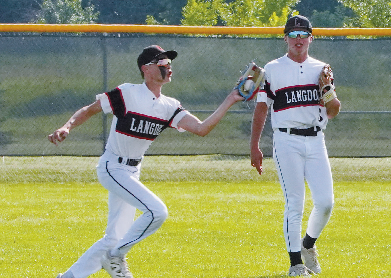 Karson Hanson makes a great catch deep between left and center field in the game against Park River. Photo by Larry Stokke.
