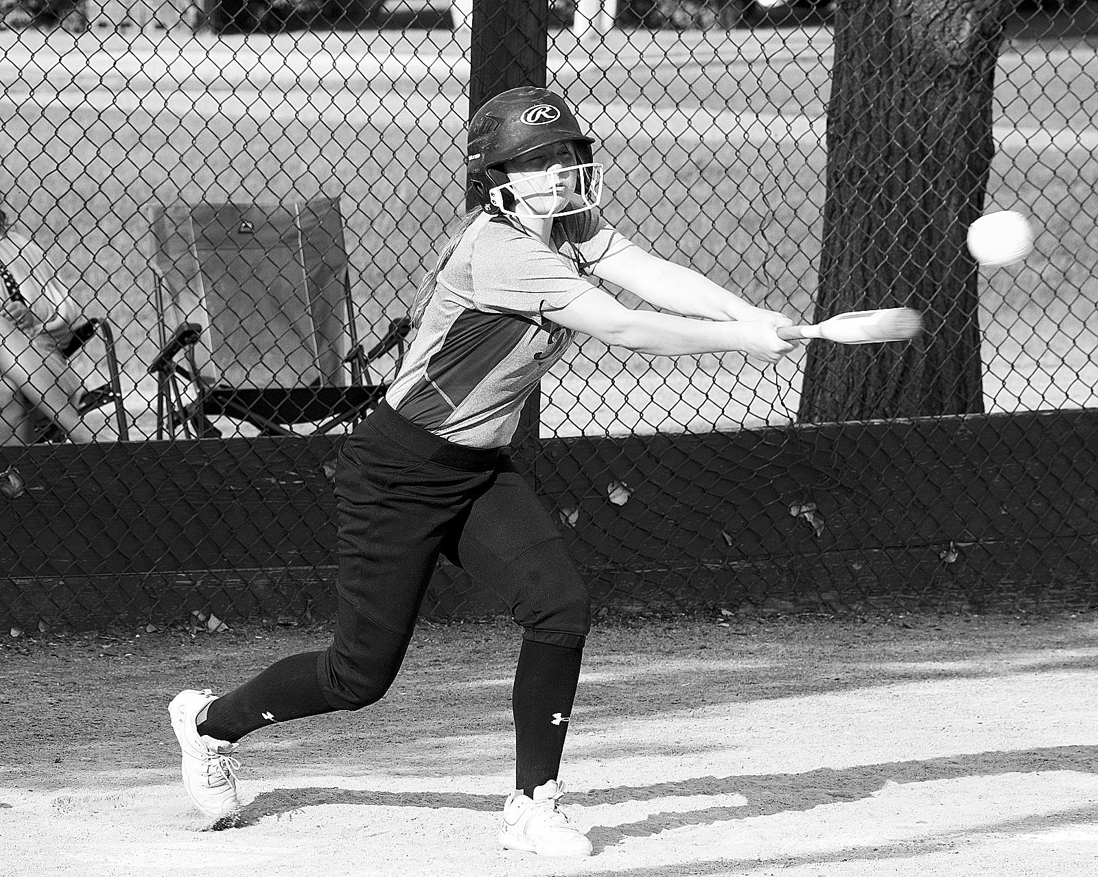 Kadence Wirth with a base hit in the Reds' win on June 25. Photo by Larry Stokke.