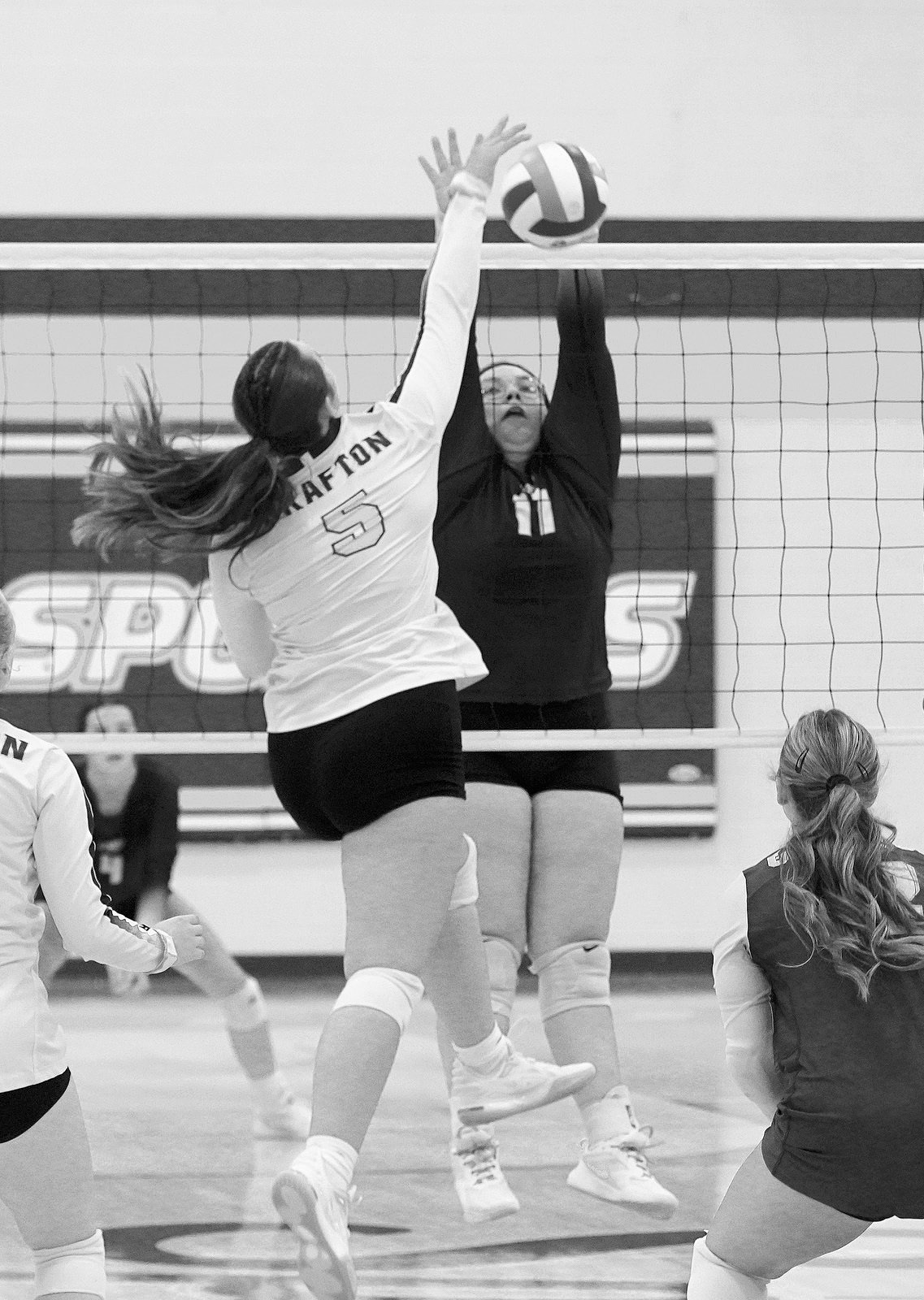 Jaelyn Forrey with a stuff block in the Eagles game against the Spoilers. Photo by Larry Stokke.